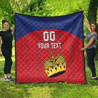 Custom football quilt spread outdoors, blue and red quilted pattern with crown logo and 'YOUR TEXT'.