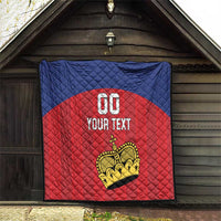 Custom football quilt hanging in an entryway, blue and red diamond stitching with crown and 'YOUR TEXT'.