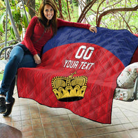Custom football quilt held on a patio, red center crown logo with '00' and 'YOUR TEXT' on blue.