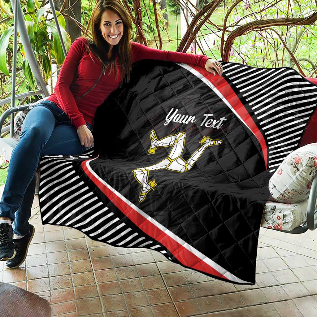 Personalized black quilt held on patio with red diagonal stripe, striped border, rider emblem