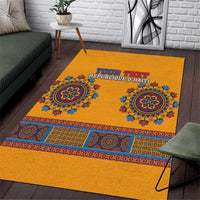 Yellow area rug with blue dashiki-style medallions and personalized text center