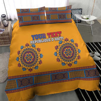 Yellow duvet and two pillows with blue medallion motifs and geometric patterned border