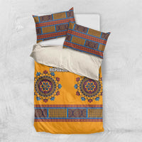 Yellow duvet cover with blue dashiki pattern and two pillows on light background