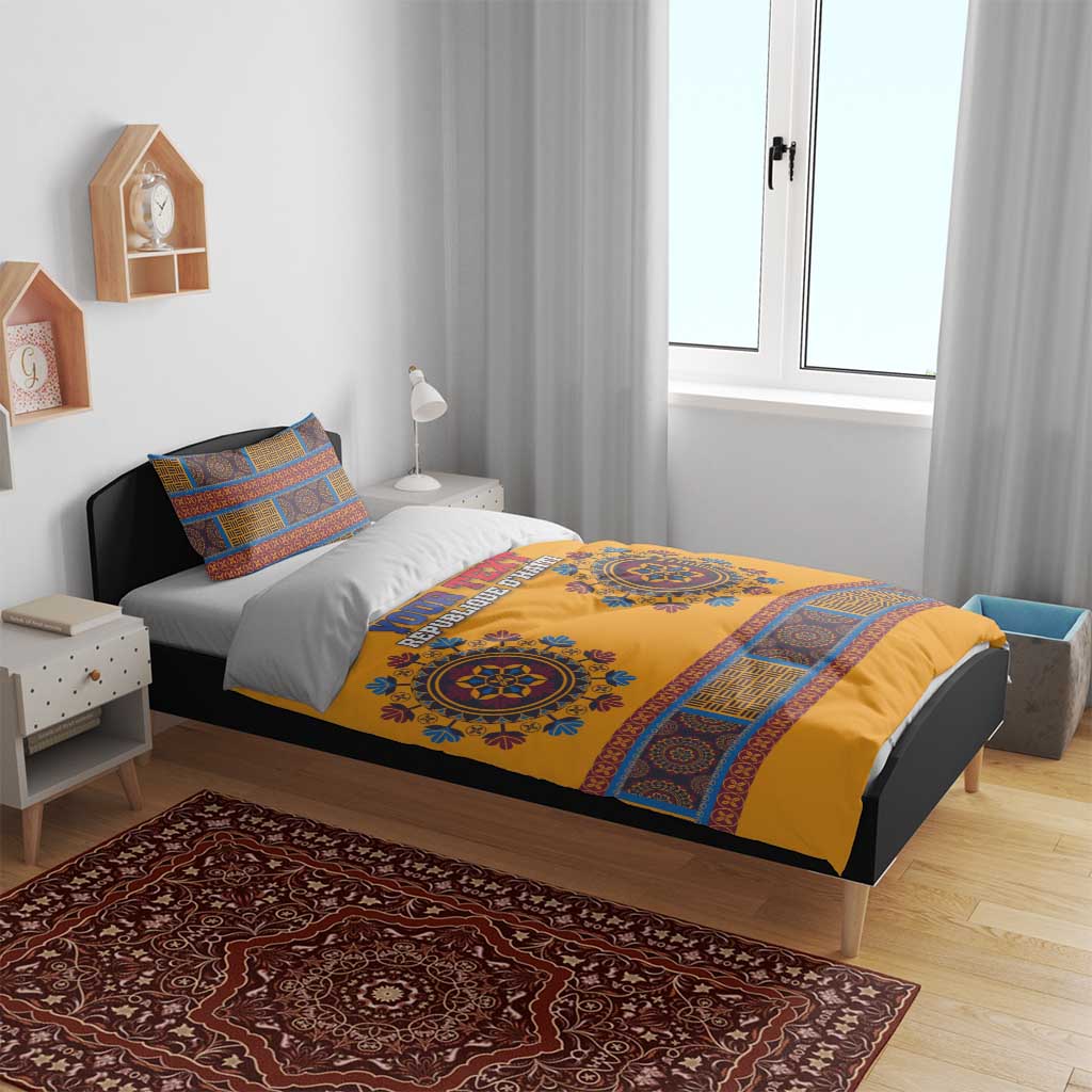 Yellow and blue patterned bedding set with two pillows on bed, geometric stripe border