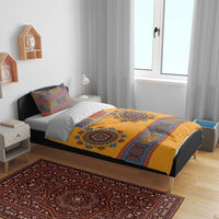 Yellow and blue patterned bedding set with two pillows on bed, geometric stripe border