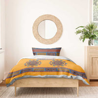 Yellow duvet with blue medallion print and geometric border, two pillows on bed