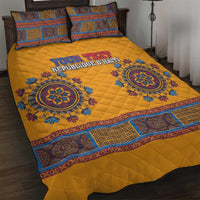 Yellow quilt bed set with blue geometric circular medallion design and matching pillows