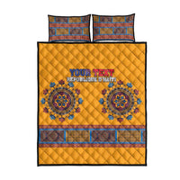 Yellow quilt bed set with blue border trim, circular medallions, and two square pillows