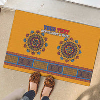 Yellow rubber doormat with blue dashiki-style band, two medallions, and “YOUR TEXT”.