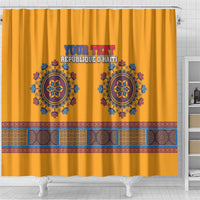 Yellow shower curtain close view with custom text, blue emblems, and multicolor patterned border
