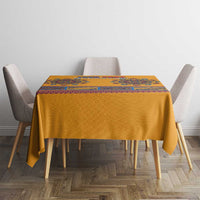 Yellow dashiki tablecloth with blue ornamental panel and border on dining table