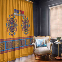 Yellow dashiki window curtain with blue emblem, red text, and patterned horizontal trim