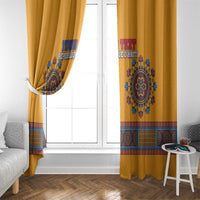 Yellow dashiki window curtain with printed emblem and border across the hem