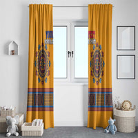 Pair of yellow dashiki window curtains with blue emblem and colorful banded print