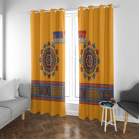 Yellow dashiki window curtains on top hooks with blue emblem and patterned band