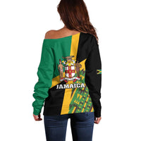 Green off-shoulder sweater with black back panel and Jamaica crest graphic