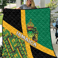 Green, yellow, and black quilt with quilted pattern, Jamaica text, and lion crest