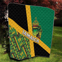 Folded green quilt with yellow stripe, black panels, Jamaica text, and lion emblem
