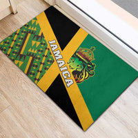 Green rubber doormat corner view with vertical 'JAMAICA' text and lion crest.