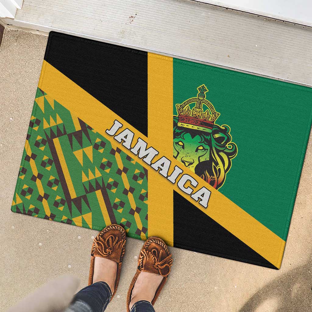 Green rubber doormat with lion crest and 'JAMAICA' lettering, shown with shoes nearby.