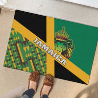 Green rubber doormat with lion crest and 'JAMAICA' lettering, shown with shoes nearby.