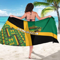 Green kente-style sarong with Jamaica text and lion crest, worn tied at back