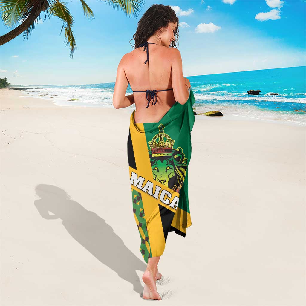 Green sarong with Jamaica lion crest and kente triangles, tied at waist for coverage