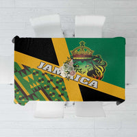 Green tablecloth with yellow, black geometric pattern and lion crest Kente-style design