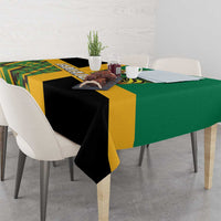 Green tablecloth with yellow border, black sections, and geometric lion patch design