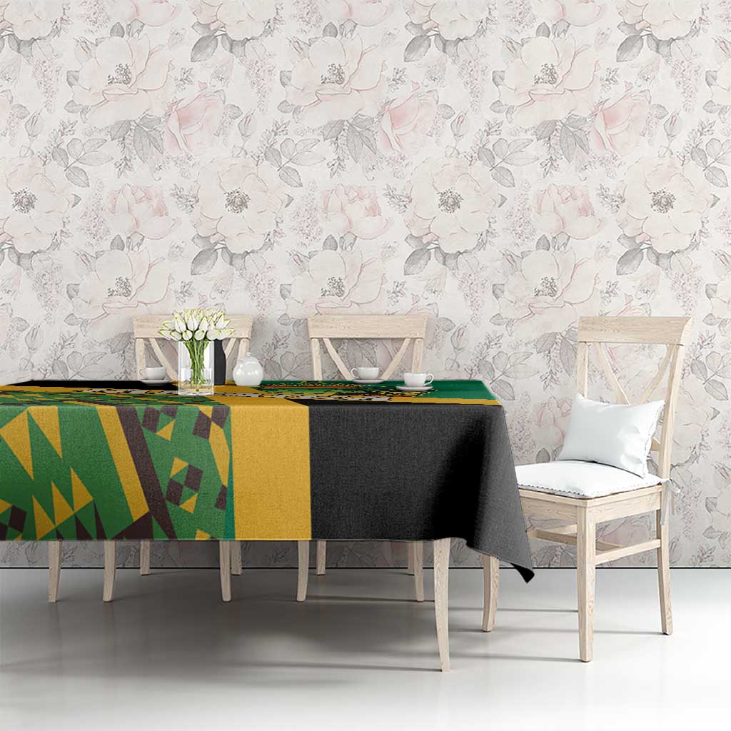 Green tablecloth with yellow and black geometric Kente pattern and lion emblem