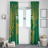 Pair of green window curtains with gold cricket player and floral artwork, hanging at doorway.