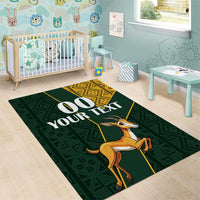 Green area rug with springbok, yellow geometric border and '00 YOUR TEXT' custom panel