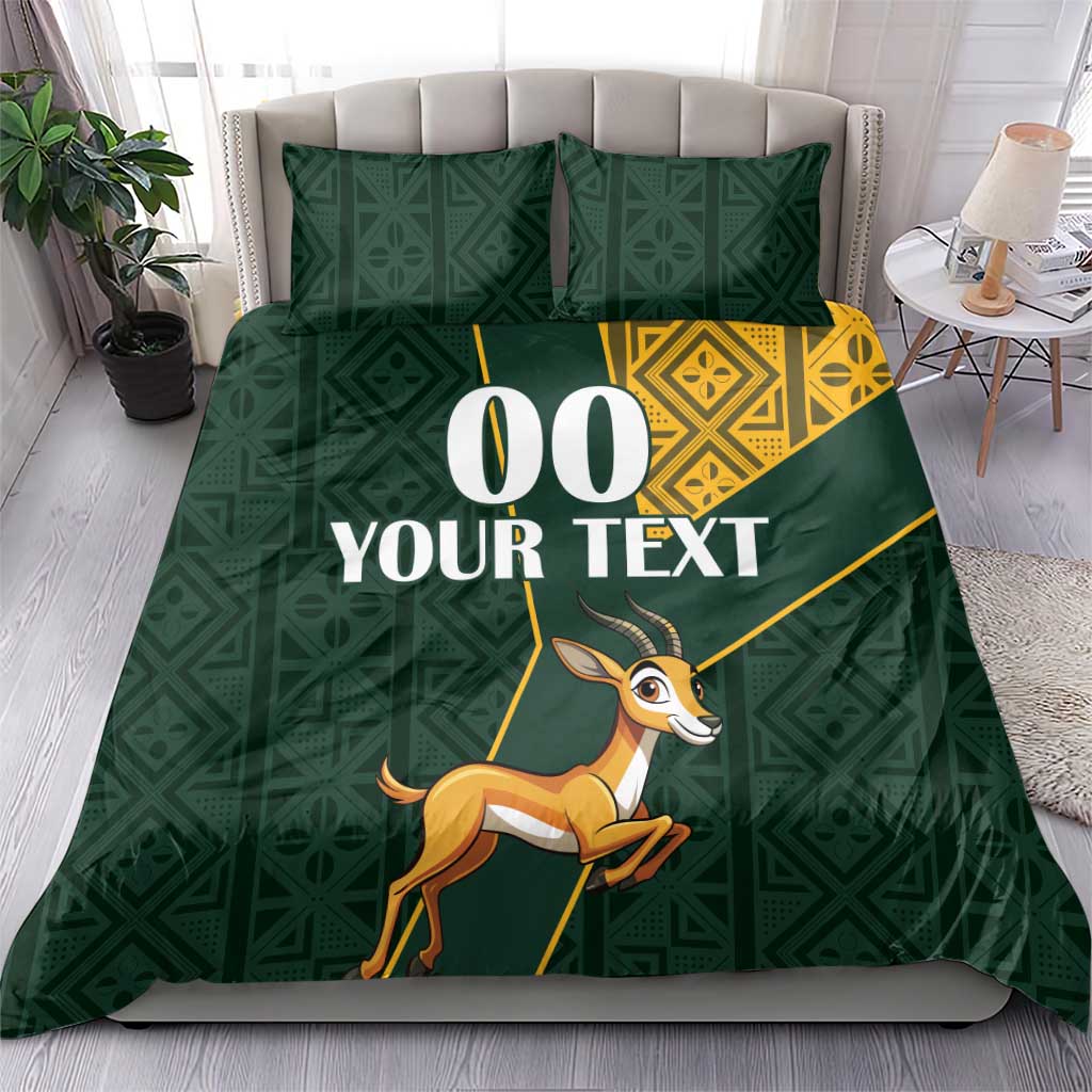 Green bedding set with yellow Kente diamond panel and springbok graphic with custom text