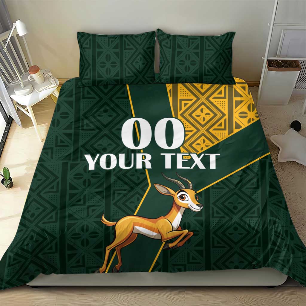 Green duvet bedding set with yellow Kente trim and springbok illustration across the center