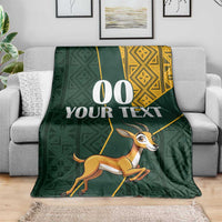 Green springbok themed blanket with yellow patterned corner and custom text