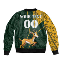 Unisex green bomber jacket back, yellow Kente right sleeve, 'YOUR TEXT' and '00' print, springbok