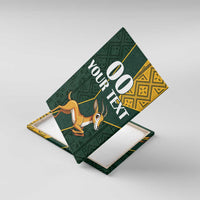 Canvas wall art angled view showing springbok, green motifs, kente panel, and “00 YOUR TEXT”