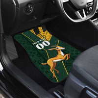 Custom car floor mat close-up with green geometric design, springbok graphic and Kente trim