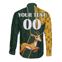 Green long-sleeve button shirt with springbok graphic and yellow kente patterns