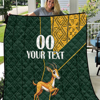 Dark green quilt with yellow Kente-style band, jumping springbok, custom “00 YOUR TEXT”