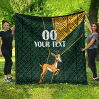 Dark green quilt blanket with yellow Kente-style corner design, springbok and “00 YOUR TEXT”