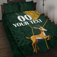 Green quilt bed set with large springbok print, white text, and yellow patterned corner