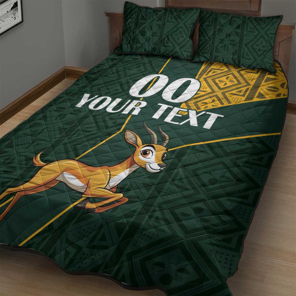 Green quilt bed set with springbok graphic, white custom text, and yellow Kente stripe