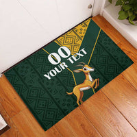 Green rubber doormat with custom 00 YOUR TEXT and springbok graphic, yellow Kente border