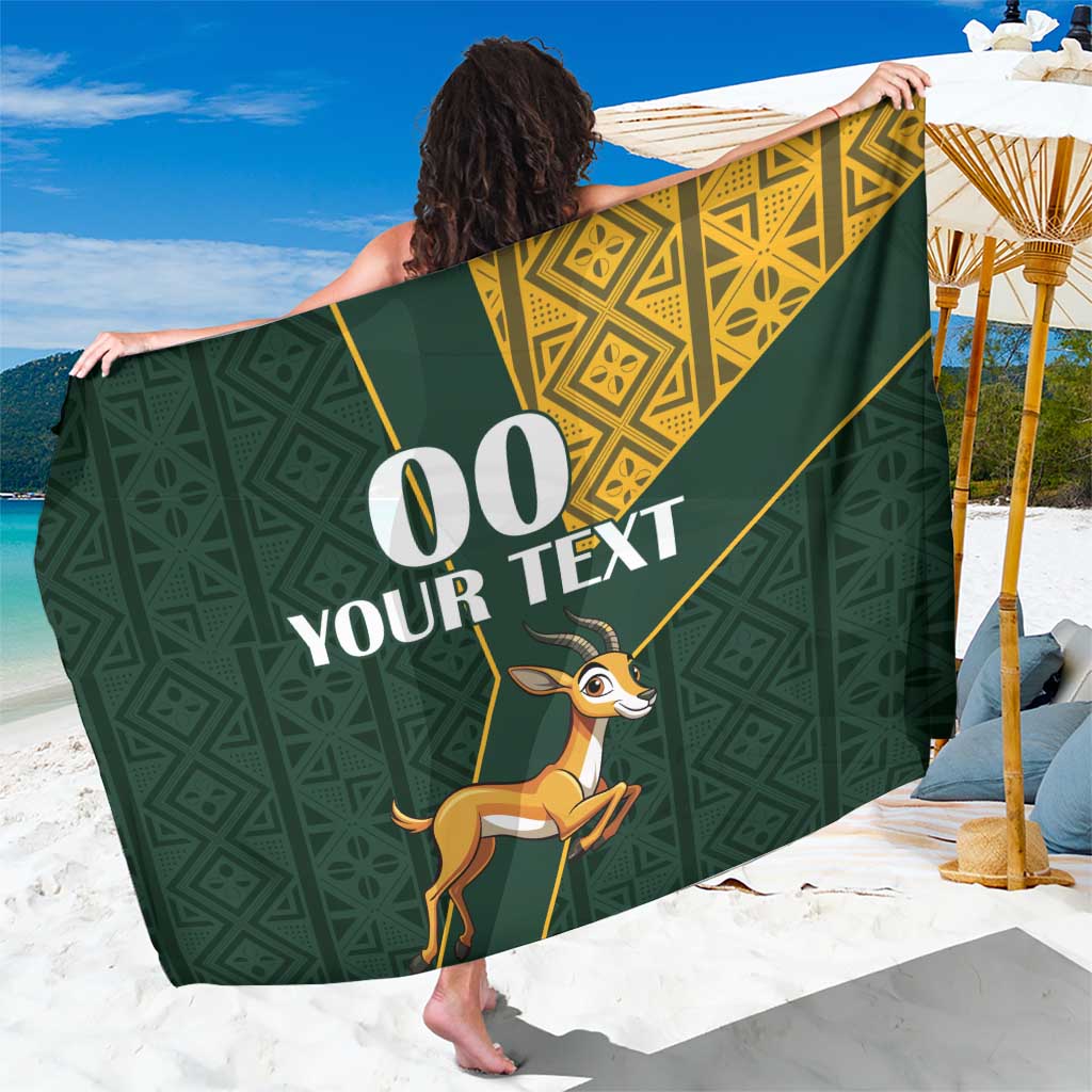 Green sarong with gold geometric kente border and springbok jumping print
