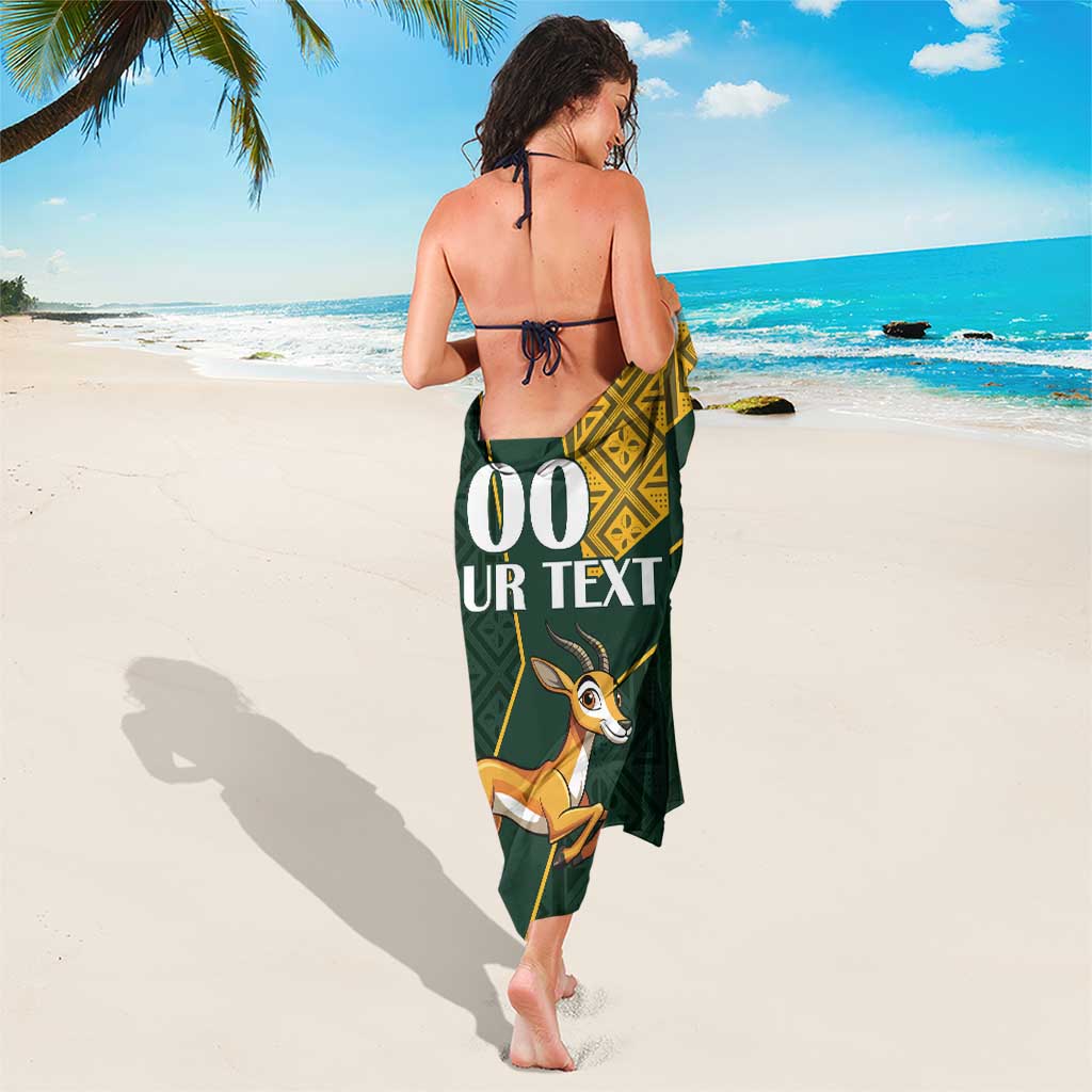 Green sarong wrap with gold kente panel and springbok print, back view