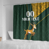 Green shower curtain with springbok graphic, geometric Kente-style panels and custom text 00 YOUR TEXT