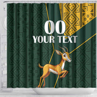 Green shower curtain with springbok illustration, gold Kente-style panels and custom text 00 YOUR TEXT