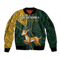 Green bomber jacket with full zip, ribbed cuffs, yellow Kente side patterns and springbok graphic