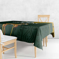 Green tablecloth with yellow geometric trim and jumping springbok graphic